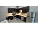 Modern kitchen featuring stainless steel appliances, dark cabinets, stylish countertops, and ample storage at 615 24Th St # 103, Golden, CO 80401