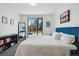 Bright bedroom with a serene view from the large window and minimalist furniture arrangement at 1601 Park Ave # 202, Denver, CO 80218
