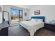 Cozy bedroom with a large window providing natural light and street view, showcasing minimalist design at 1601 Park Ave # 202, Denver, CO 80218