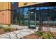 Inviting building entrance with modern glass doors, landscaped walkway and clean contemporary lines at 1601 Park Ave # 202, Denver, CO 80218