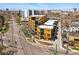 Modern condos feature light wood and black siding with many windows in this aerial view at 1601 Park Ave # 202, Denver, CO 80218