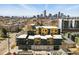 Condo with modern architecture in an aerial shot showing the distant skyline at 1601 Park Ave # 202, Denver, CO 80218