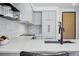 Close-up showcasing elegant kitchen featuring quartz countertops, modern backsplash, and premium finishes at 1601 Park Ave # 202, Denver, CO 80218