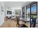 Bright and airy living room featuring large windows, hardwood floors, and an open dining area at 1601 Park Ave # 202, Denver, CO 80218