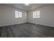 Cozy bedroom featuring gray flooring and natural light from two windows, perfect for relaxation and comfort at 69101 E 72Nd Ave, Byers, CO 80103