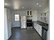 Bright kitchen features stainless steel appliances, white cabinets, and wood-look floors at 69101 E 72Nd Ave, Byers, CO 80103