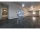 Spacious living room featuring modern gray flooring, recessed lighting, and an open layout with kitchen and bathroom views at 69101 E 72Nd Ave, Byers, CO 80103