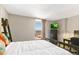 Bright bedroom featuring a large window with cityscape views, plus a dark wood bed frame and desk at 1020 15Th St # 16A, Denver, CO 80202