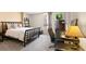 Comfortable bedroom featuring a large window, a dark wood bed frame and a dedicated workspace at 1020 15Th St # 16A, Denver, CO 80202