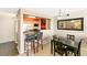 Open dining area with a bar and kitchen view, featuring dark wood table and chairs and modern pendant lighting at 1020 15Th St # 16A, Denver, CO 80202