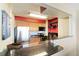 Modern kitchen with granite countertops, stainless steel appliances, breakfast bar, and red wall accent at 1020 15Th St # 16A, Denver, CO 80202
