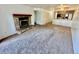Inviting living room featuring a stone fireplace and seamless flow into the adjacent kitchen at 16001 E Alaska Pl # 7, Aurora, CO 80017