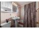 Pink tiled bathroom with tub and shower at 5341 S Sherman St, Littleton, CO 80121