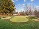 Landscaped putting green with sand traps and flags at 18950 E Geddes Ave, Centennial, CO 80016