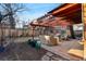 Backyard with a stone patio, covered pergola, and cozy outdoor seating area at 357 Birch St, Denver, CO 80220