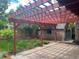 Spacious backyard patio with pergola, a brick shed, and lovely green lawn at 357 Birch St, Denver, CO 80220