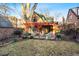 Backyard featuring a covered patio with seating, adjacent to a well-maintained lawn at 357 Birch St, Denver, CO 80220