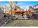 Backyard with a patio covered by a pergola, outdoor seating and a well-kept lawn at 357 Birch St, Denver, CO 80220