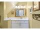 The bathroom features a sink with white cabinets and a stone countertop, as well as a large mirror at 357 Birch St, Denver, CO 80220