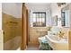 Traditional bathroom with yellow tile, a window with blind and a black and white tiled floor at 357 Birch St, Denver, CO 80220