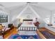 Sun-filled bedroom with vaulted ceilings, hardwood floors, and built-in seating area by the window at 357 Birch St, Denver, CO 80220