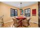 Cozy dining room with a round red table, black windows and four wicker chairs at 357 Birch St, Denver, CO 80220