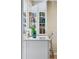 Bright kitchen with white cabinets, marble countertop, decorative glass cabinets and stylish fixtures at 357 Birch St, Denver, CO 80220
