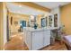 Bright eat-in kitchen features an island with white cabinets, a marble countertop, and hardwood floors at 357 Birch St, Denver, CO 80220
