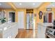 Bright kitchen with stainless steel refrigerator, white cabinets, hardwood floors, and marble countertops at 357 Birch St, Denver, CO 80220