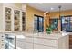 Well lit kitchen with white cabinets, marble countertop island, and stainless steel dishwasher at 357 Birch St, Denver, CO 80220