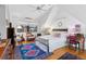 Vaulted ceiling main bedroom features a large window, hardwood floors and colorful rugs at 357 Birch St, Denver, CO 80220