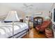 Bright bedroom features a white ceiling fan, hardwood floors, and a red patterned chair at 357 Birch St, Denver, CO 80220