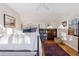 Spacious bedroom with a white bed, hardwood floors, a cozy rug, and a large window at 357 Birch St, Denver, CO 80220