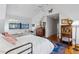 Bedroom features a daybed by the window, white walls, and hardwood floors at 357 Birch St, Denver, CO 80220