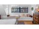 Bedroom window seat features patterned pillows, a warm blanket, and a large window at 357 Birch St, Denver, CO 80220