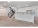 Finished basement with a wet bar, and modern black stair railing that add to its functionality and stylish look at 8658 Pennycress Dr, Littleton, CO 80125
