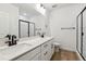 Contemporary bathroom featuring double sinks, modern fixtures, and a glass-enclosed shower, enhanced by sleek design at 8658 Pennycress Dr, Littleton, CO 80125