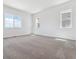 Bright bedroom with carpet and three large windows at 8658 Pennycress Dr, Littleton, CO 80125