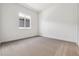 Bright bedroom with plush carpet flooring, white walls, and a window offering natural light at 8658 Pennycress Dr, Littleton, CO 80125