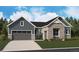 Charming exterior showcasing a blend of stone and siding, a two-car garage, and a well-manicured lawn at 8658 Pennycress Dr, Littleton, CO 80125