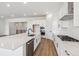 Spacious kitchen with stainless steel appliances, white cabinets, and hardwood floors at 8658 Pennycress Dr, Littleton, CO 80125