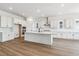 Well-lit kitchen featuring white cabinets, stainless steel appliances, and a center island at 8658 Pennycress Dr, Littleton, CO 80125