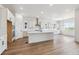 Bright, modern kitchen with an island, stainless steel vent hood, and scenic views at 8658 Pennycress Dr, Littleton, CO 80125