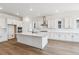 Beautiful kitchen featuring white cabinets, an island, and stainless steel appliances at 8658 Pennycress Dr, Littleton, CO 80125