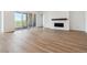 Bright living room with wood floors, a cozy fireplace, and large windows offering natural light at 8658 Pennycress Dr, Littleton, CO 80125