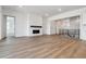 Bright living room with a fireplace, modern finishes, and hardwood floors at 8658 Pennycress Dr, Littleton, CO 80125
