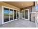 Large patio with multiple sliding glass doors, offering panoramic views of the surrounding landscapes and outdoor living at 8658 Pennycress Dr, Littleton, CO 80125