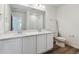 Bathroom featuring double vanity, quartz countertop, and tile flooring at 9151 Telluride Ct, Commerce City, CO 80022