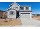 Charming two-story home featuring a gray exterior, well-manicured landscaping, and an attached two-car garage at 9151 Telluride Ct, Commerce City, CO 80022