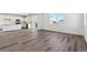 Bright and spacious living room featuring wood-look flooring and a modern, open floor plan at 9151 Telluride Ct, Commerce City, CO 80022